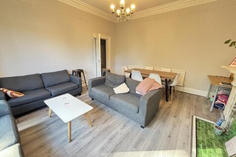 A spacious and well-maintained living room with...