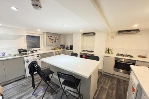 A modern and spacious living room featuring amp...