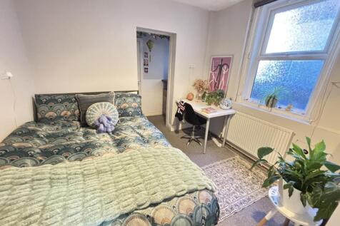 A bright and inviting bedroom with a spacious d...