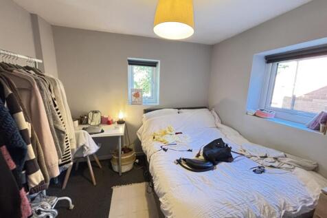 A cozy bedroom with a comfortable double bed, w...