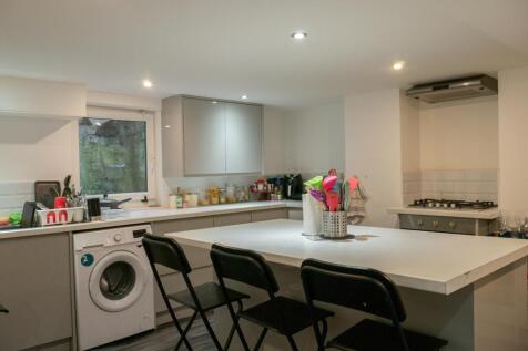 A modern and bright kitchen with ample counter ...