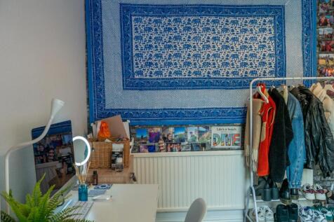 A bright and well-maintained bedroom featuring ...