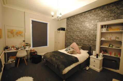 A cozy and well-maintained bedroom featuring a ...