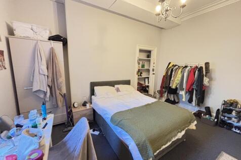 A well-maintained bedroom featuring a comfortab...