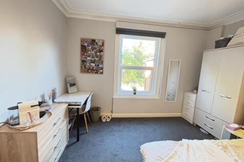 A bright and well-maintained bedroom featuring ...