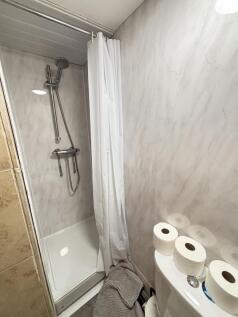 A clean and functional bathroom featuring a sho...