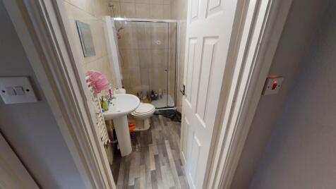 A clean and modern bathroom with a shower and b...