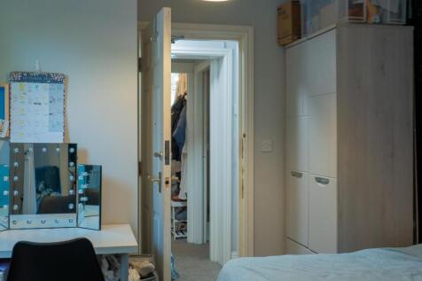 A tidy bedroom with natural light coming throug...