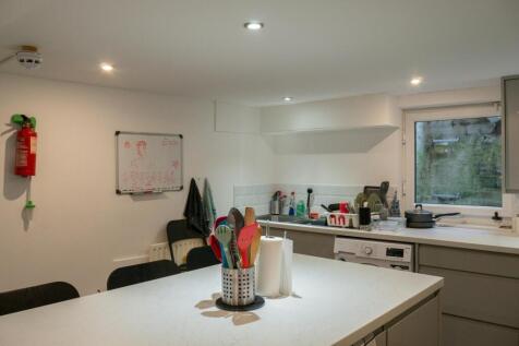 A bright and tidy kitchen area featuring modern...