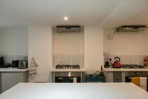 Modern kitchen area with appliances and bright ...