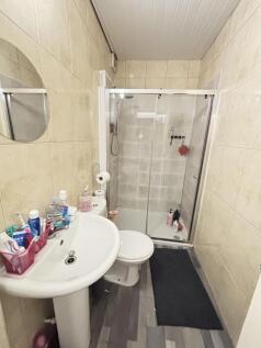 A clean and functional bathroom with a shower e...