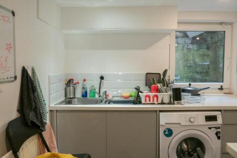 A bright and functional kitchen with a window p...