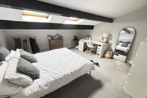 Bright and airy master bedroom with large windo...