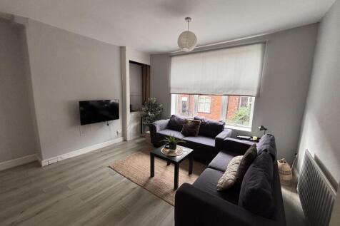 A bright and modern living room with large wind...