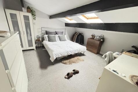 A bright and airy bedroom featuring a large dou...