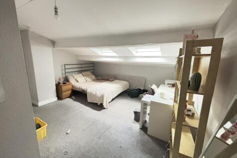 Bright and spacious master bedroom featuring a ...