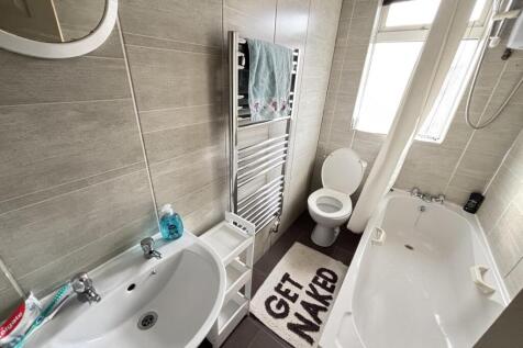 A modern, bright bathroom with a spacious bath ...