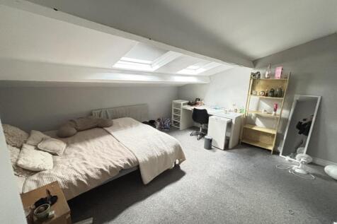 A bright and cozy bedroom with a double bed, fe...