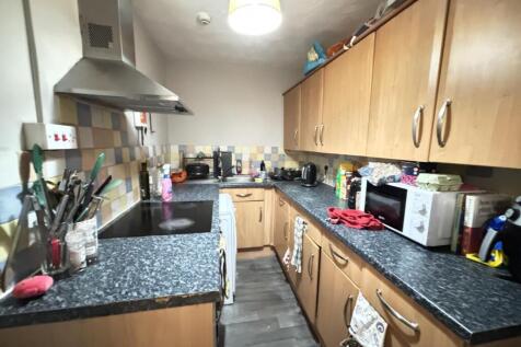 A well-equipped kitchen featuring wooden cabine...