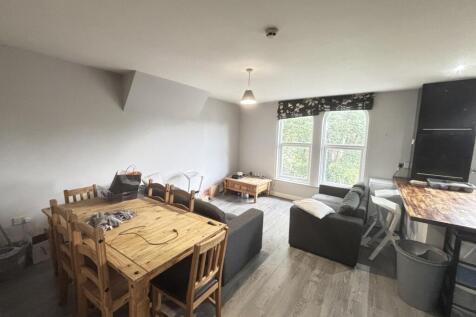 A bright and welcoming living room featuring a ...