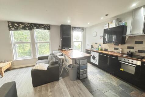 A modern and spacious living room featuring lar...