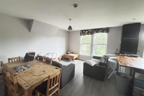 Bright and welcoming living room with ample nat...