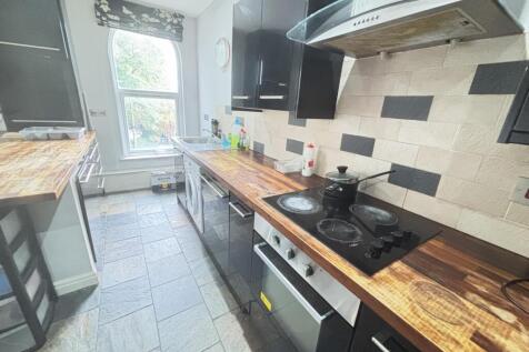 Bright and modern kitchen with ample natural li...