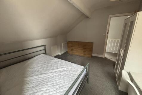 A well-maintained bedroom featuring a comfortab...