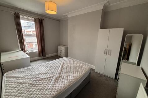A well-maintained bedroom featuring a double be...