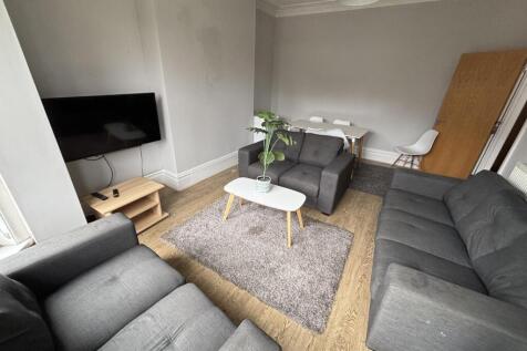 A spacious and inviting living room filled with...