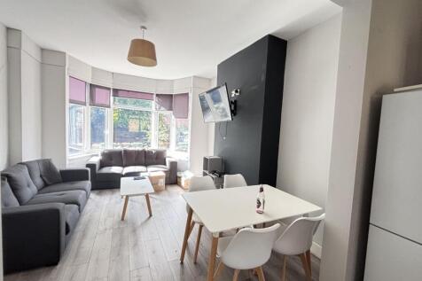 A bright and welcoming modern living room featu...