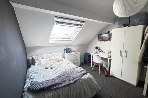 A cozy bedroom with a single bed, bright natura...