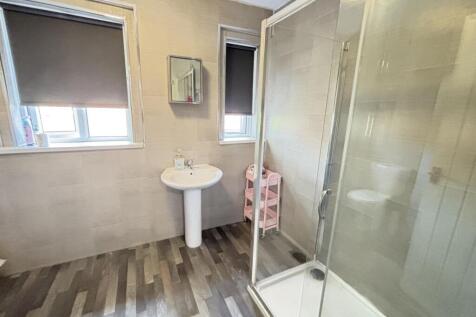 Bright and well-maintained bathroom with a show...