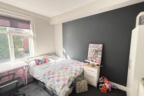 A bright and welcoming bedroom featuring a doub...