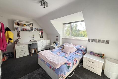 A cozy bedroom with a double bed, natural light...