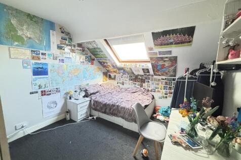 A cozy bedroom featuring vibrant wall decoratio...