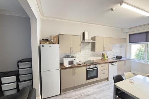 Modern kitchen area with ample natural light, f...