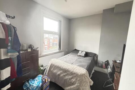 Spacious and well-lit master bedroom featuring ...