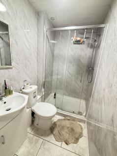 A clean, modern bathroom featuring a spacious s...