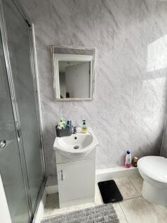 A modern, tidy bathroom featuring a sink with m...