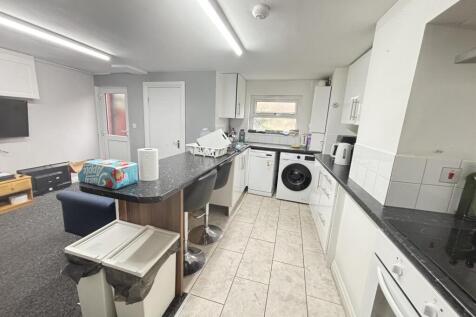 A modern, bright kitchen with ample countertop ...