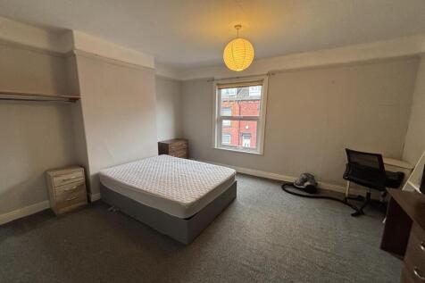 Spacious and well-lit master bedroom featuring ...