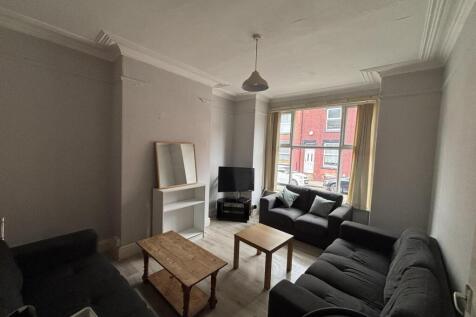 A bright and inviting living room featuring com...