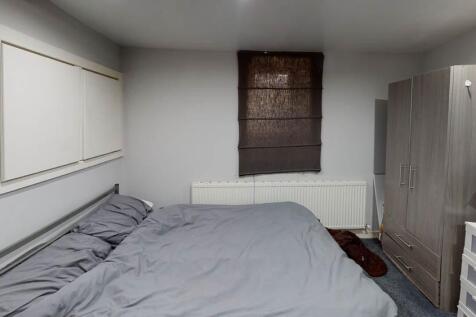 A cozy bedroom featuring a double bed and a war...