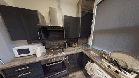 A modern kitchen with various appliances and wo...