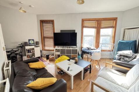 A bright and welcoming living room featuring la...