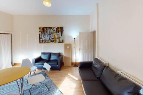 A bright and welcoming living room featuring co...