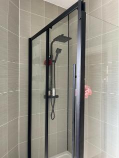 A modern, clean bathroom with a spacious shower...