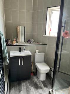 A modern and clean bathroom with a toilet, a sm...