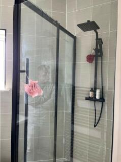 A modern bathroom shower area featuring a sleek...